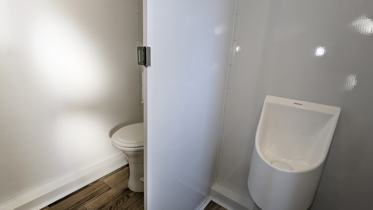 A bathroom with a toilet and a urinal.