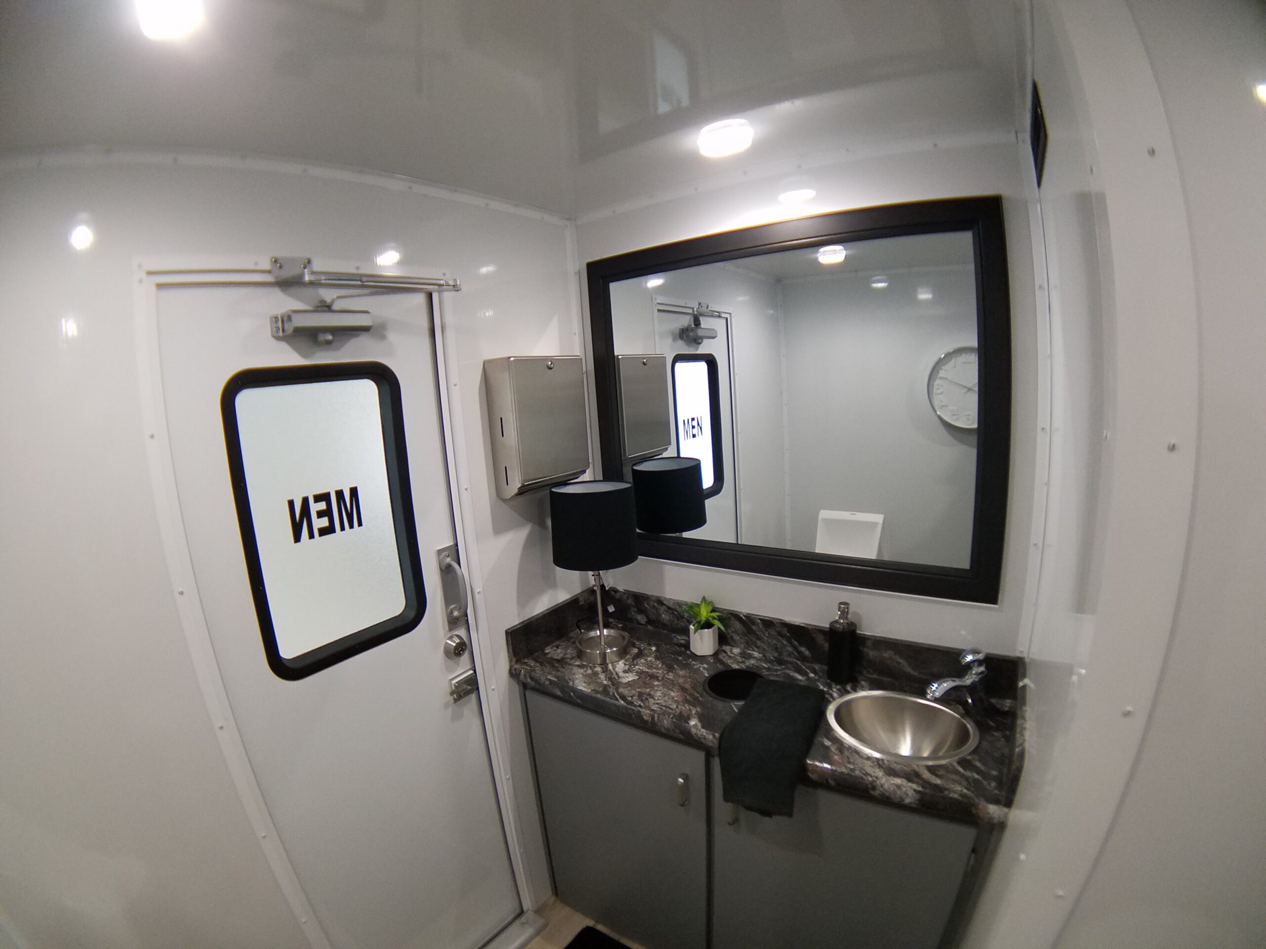 A bathroom with a sink, mirror and toilet.