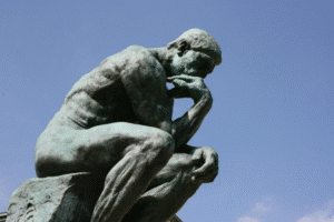 Rodin’s “The Thinker” statue against a clear sky.