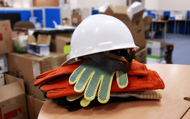 White hard hat and work gloves symbolizing Labor Day workers.