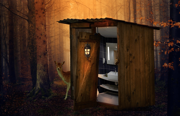 Rustic wooden outhouse in a forest revealing a modern, well-lit restroom inside.